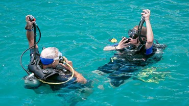 Blue Coral Diving - PADI Dive Center Hoi An Vietnam | 2 Scuba Divers at the surface getting ready for their descent.