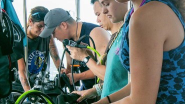 Blue Coral Diving - PADI Dive Center Hoi An Vietnam | Hoi An Diving Center | 5 scuba divers getting ready equipment check and setup.