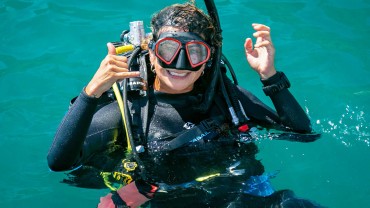 Blue Coral Diving - PADI Dive Center Hoi An Vietnam Happy Scuba Diver Girl at the surface Thumbs Up!